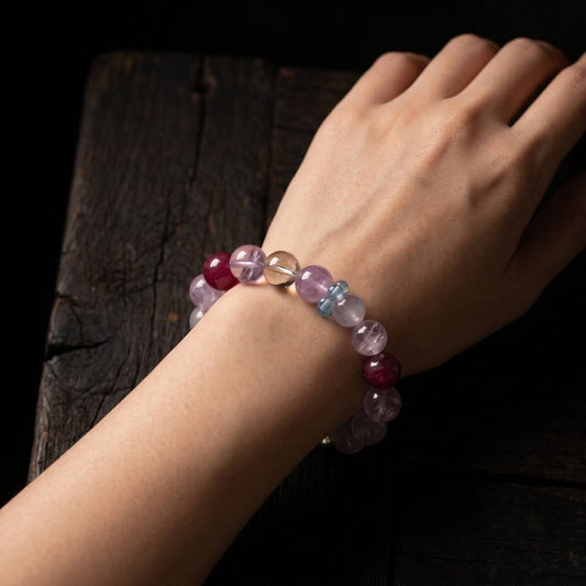 10mm clear-toned crystal and rose quartz bracelet shown on the left wrist