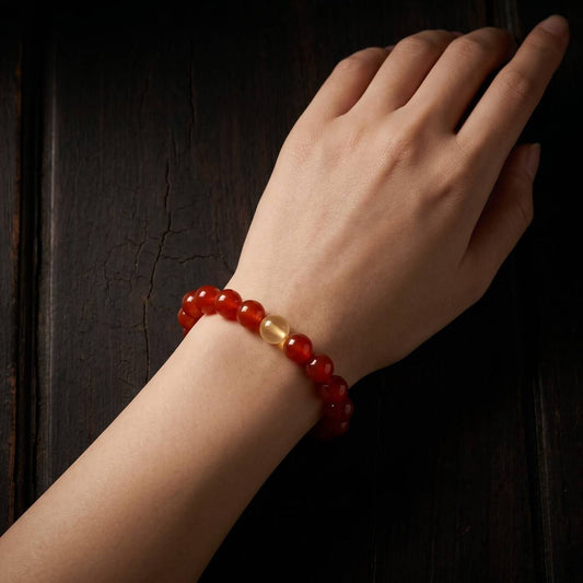 Natural 10mm Red Crystal bracelet shown on the left wrist