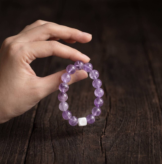 Soft purple 10mm amethyst beads shown in a close-up view