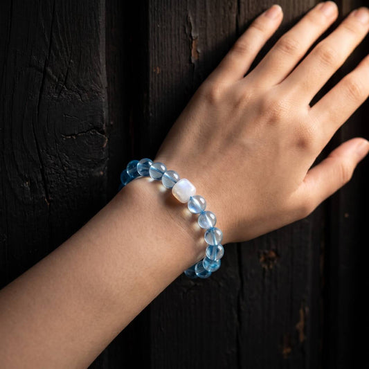 Clear blue 10mm aquamarine bracelet worn on the wrist