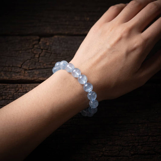 Icy pale blue 10mm aquamarine bracelet worn on the wrist