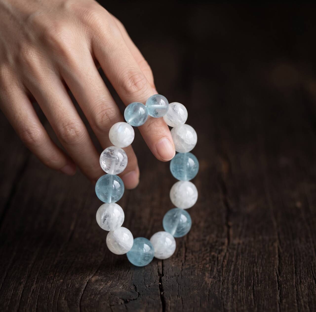 Aquamarine and Snow White Phantom Quartz bracelet held in hand in natural light
