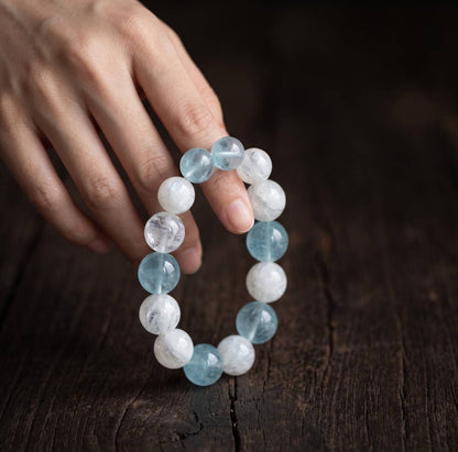 Aquamarine and Snow White Phantom Quartz bracelet held in hand in natural light