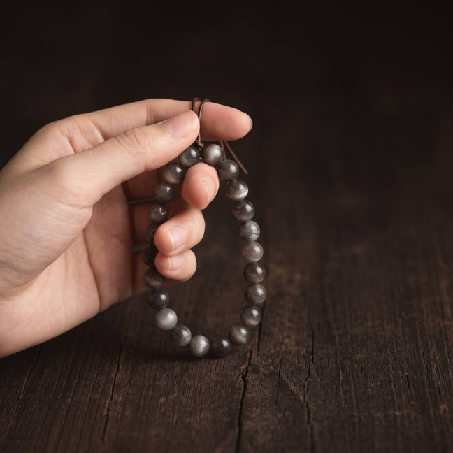 Black Gold Sunstone bracelet held in hand in natural light