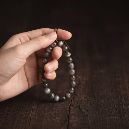 Black Gold Sunstone bracelet held in hand in natural light