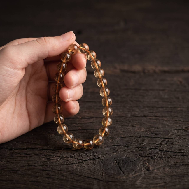 7mm citrine bracelet held in hand under natural light