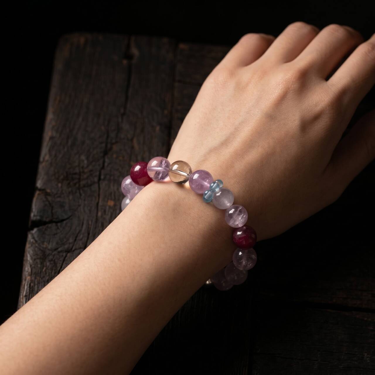 10mm clear-toned crystal and rose quartz bracelet shown on the left wrist
