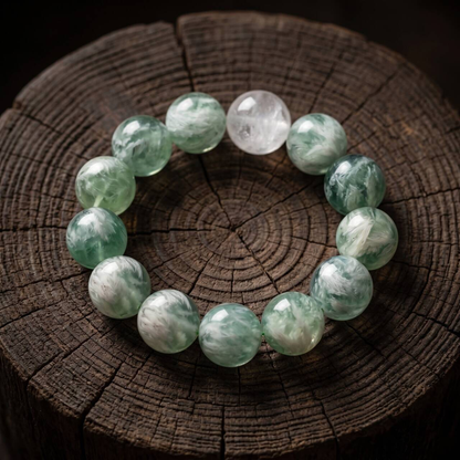 Green-and-white marbled 10mm bead bracelet arranged on a dark wooden surface