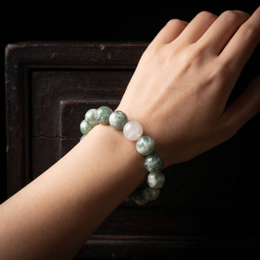 Green-and-white marbled 10mm bead bracelet worn on a wrist