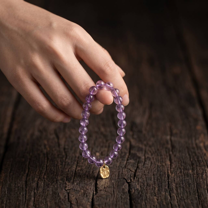 6mm amethyst bracelet held in hand in natural light