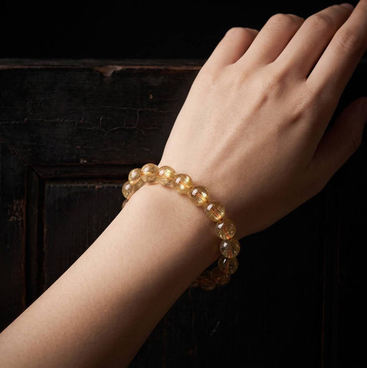 Natural 10mm citrine bracelet shown on the left wrist