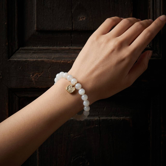 Natural 7mm Hetian jade bracelet worn on the wrist in soft natural light