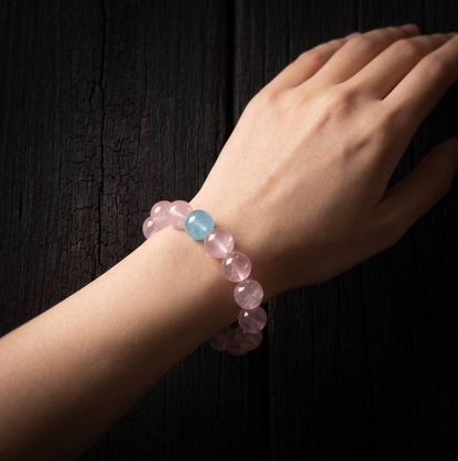 10mm rose quartz and aquamarine bracelet shown on the wrist