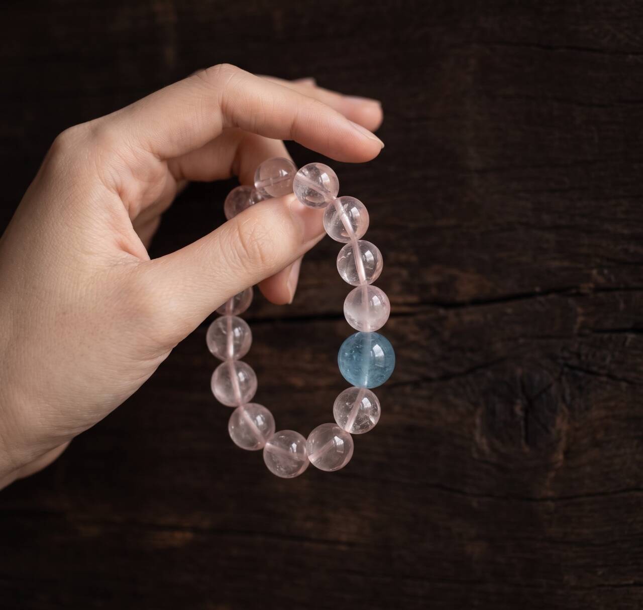 10mm Rose Quartz bracelet held in hand under natural light
