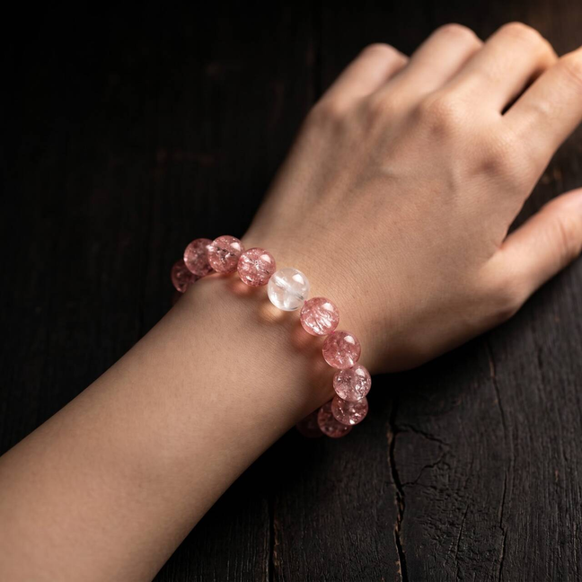10mm rose quartz beaded bracelet shown on a wrist