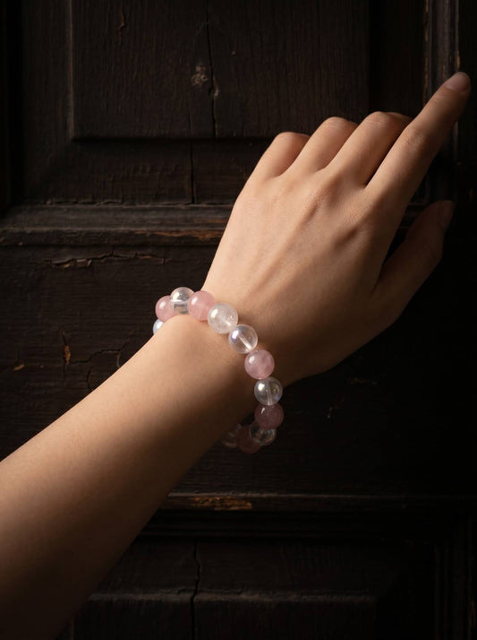 10mm rose quartz, White Crystal, and White Phantom Quartz bracelet shown on the wrist