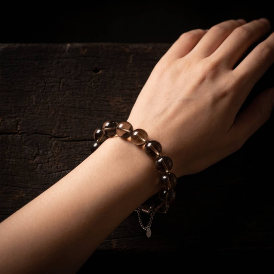 Smoky brown translucent 10mm bead bracelet worn on a wrist