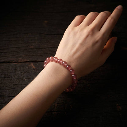7mm Strawberry Quartz bracelet shown on the wrist